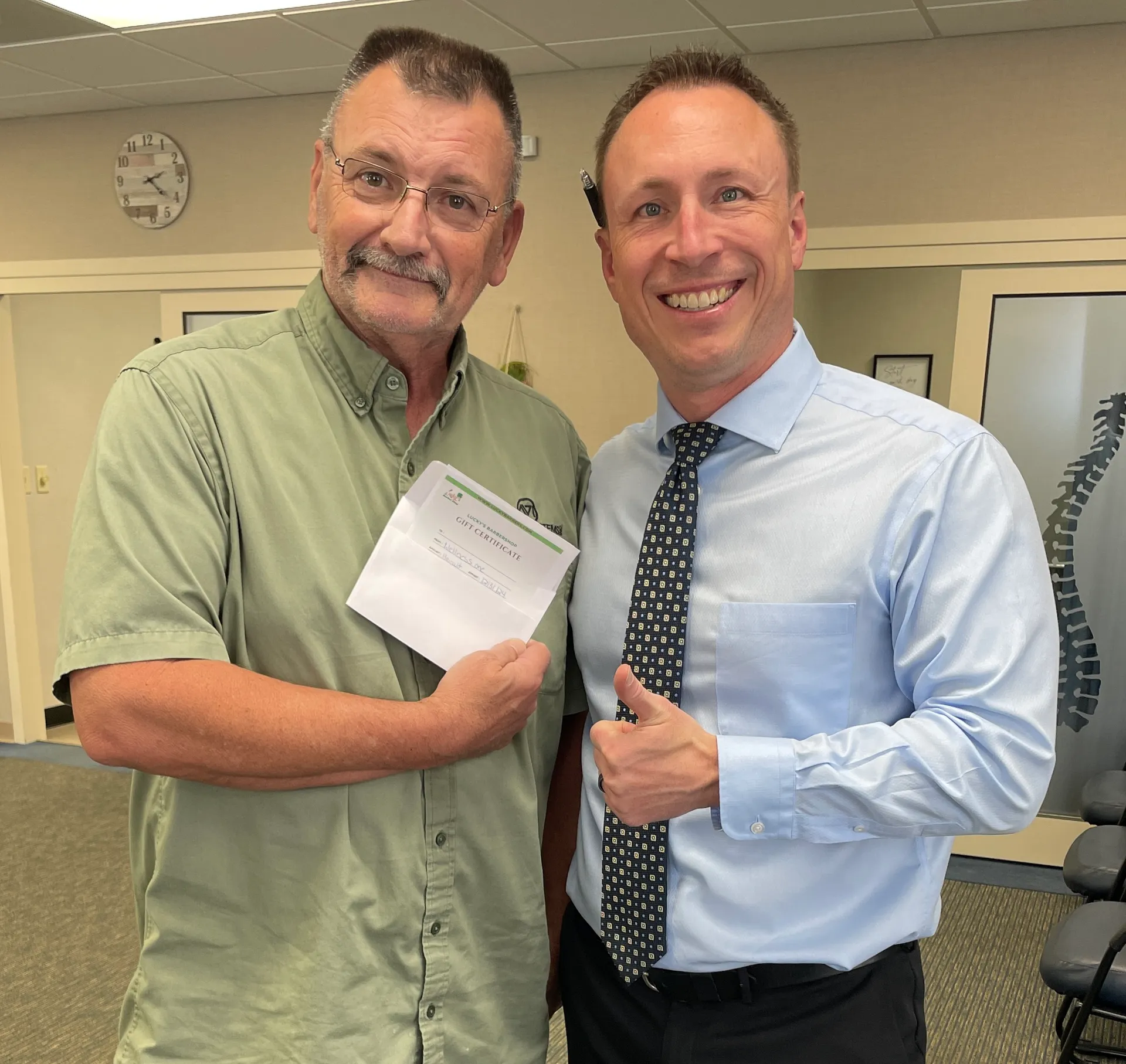 Dr. Charlie Gray with patient after successful chiropractic session