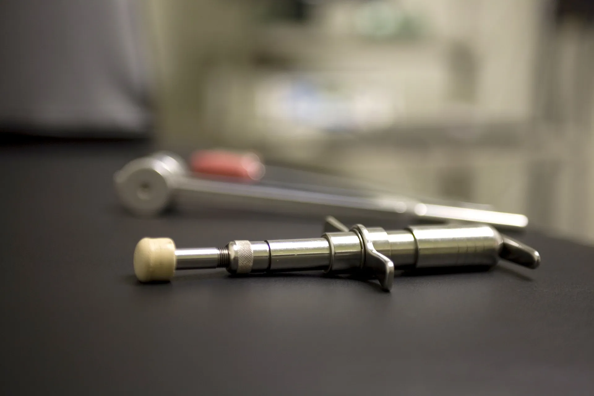 Two Activator adjusting instruments lying on a dark table