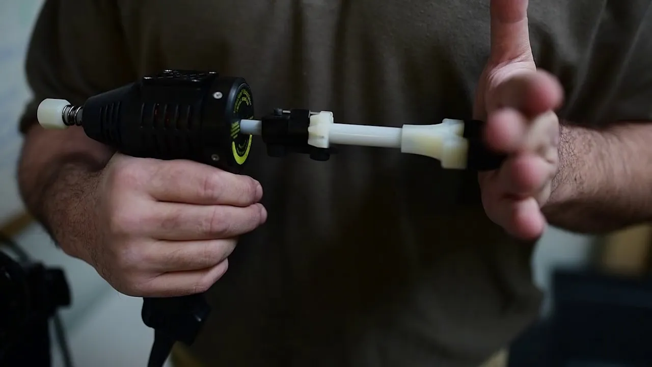 Close-up of a hand holding an ArthroStim adjusting instrument