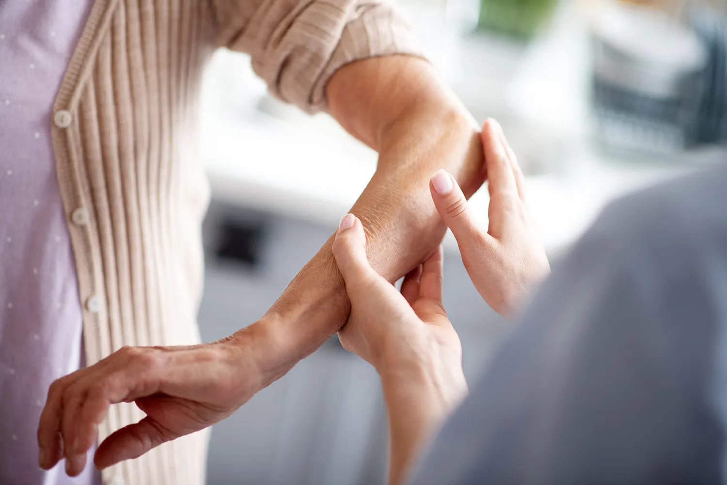 old woman getting check her arm pain