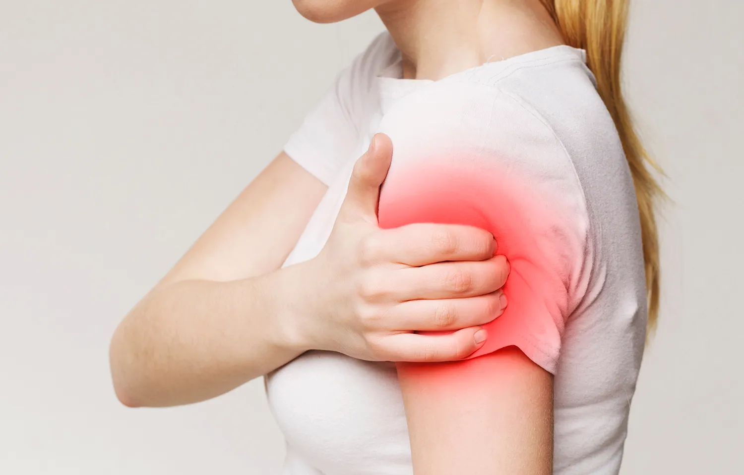 woman touches her arm pain