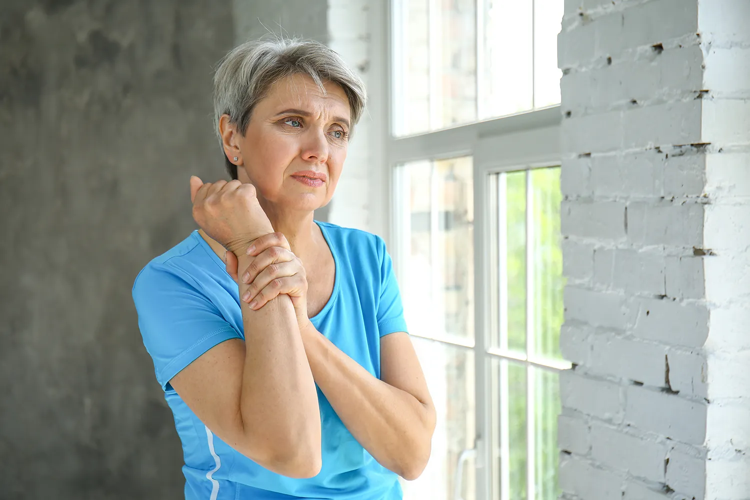 old woman suffering from arm pain