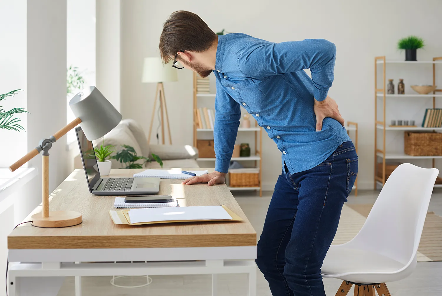 man suffering from lower back pain from pinched nerve