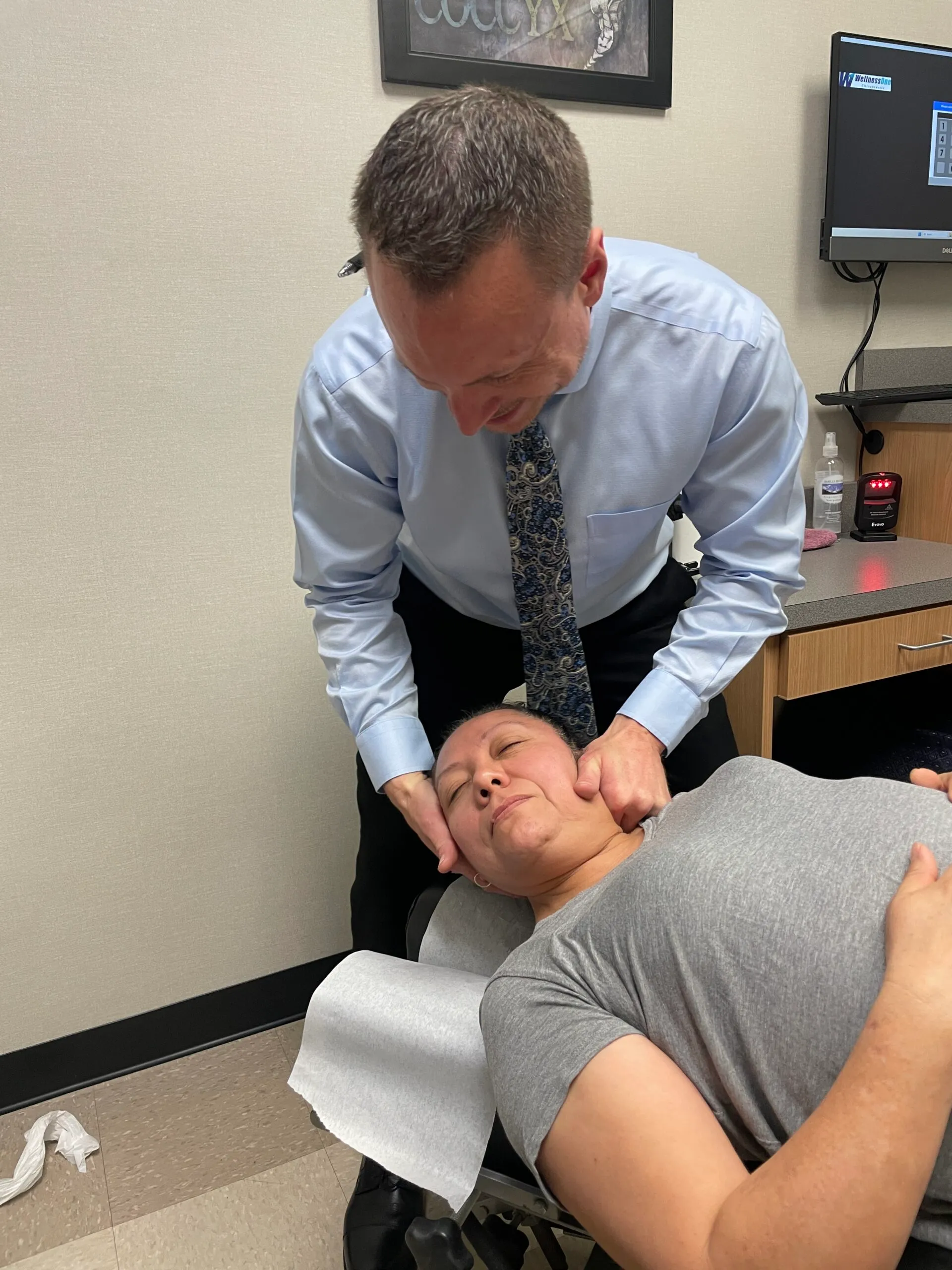 Dr. Charlie Gray giving the patient a whiplash treatment