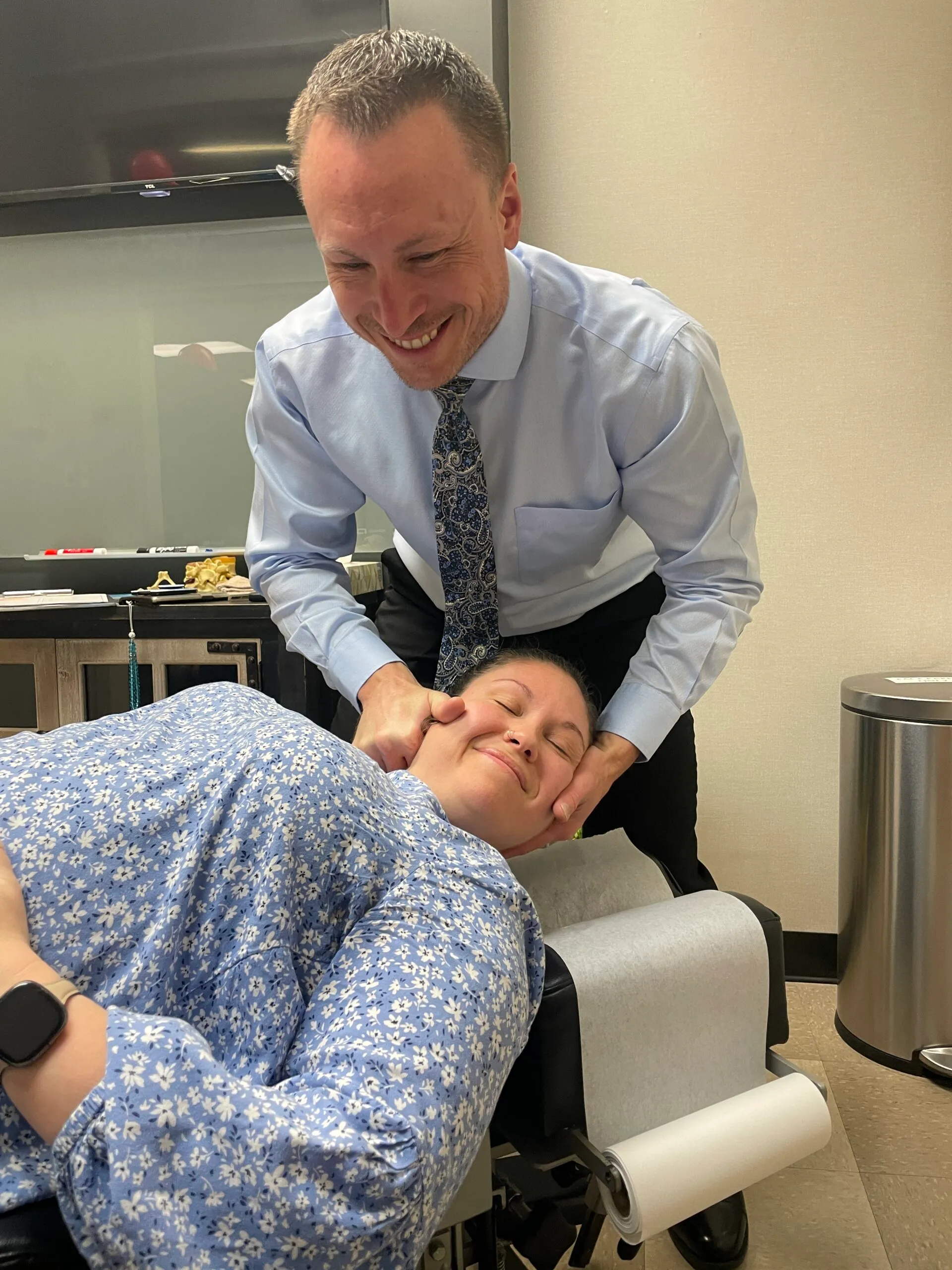 Dr. Charlie Gray giving patient neck pain treatment